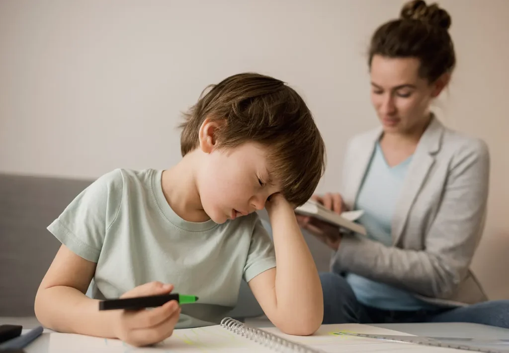 A tired child being tutored at home